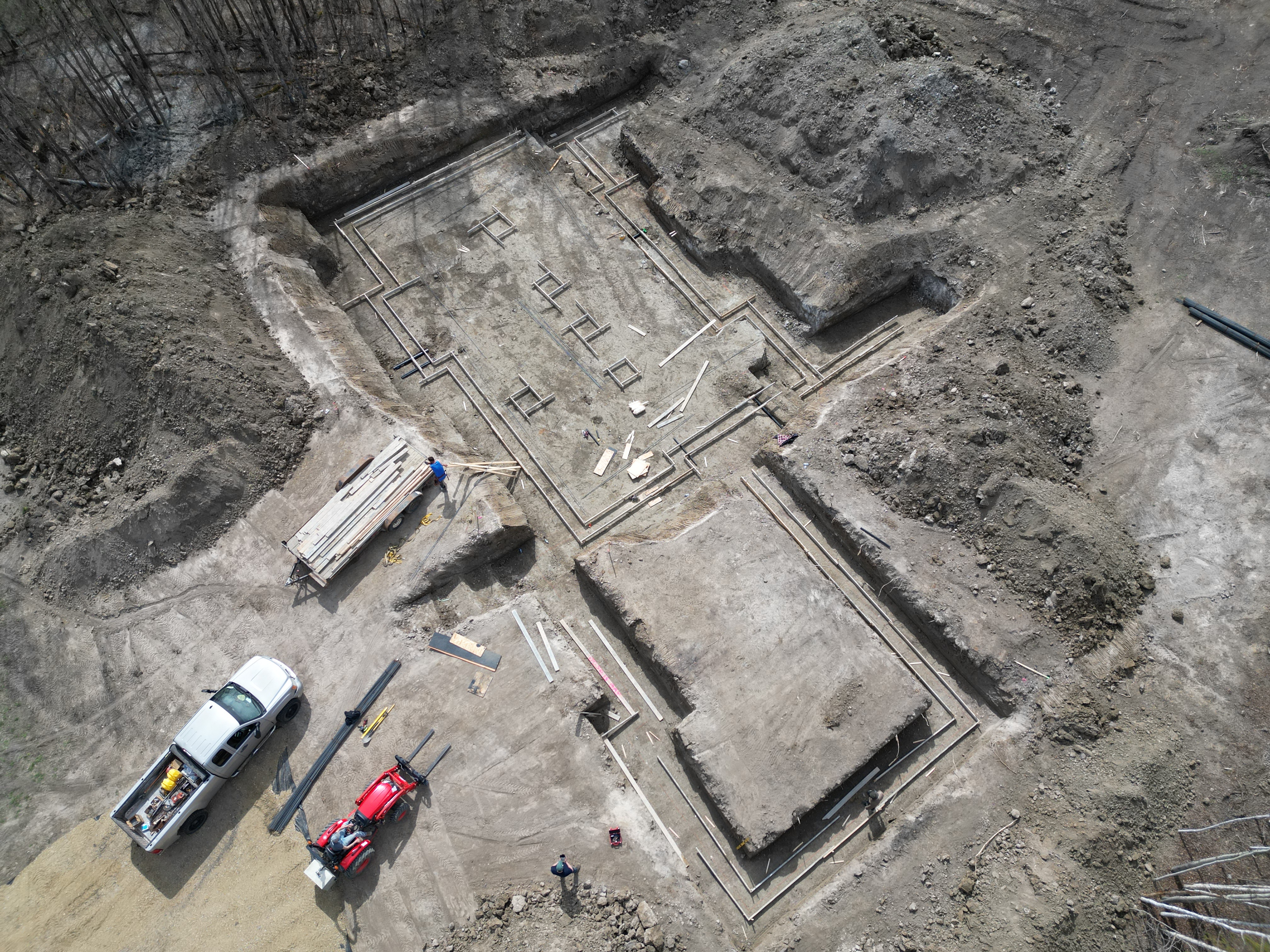 Aerial view of foundation excavation and forming on a residential construction site